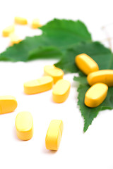 Image showing vitamin pills over green leaves