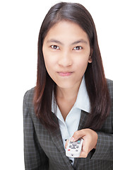 Image showing Businesswoman pushing remote control