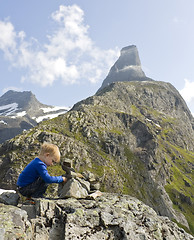 Image showing Child building a cairn