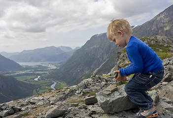 Image showing Child building a cairn