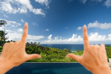 Image showing Hands Framing Breathtaking Hawaiian Ocean View Deck and Pool