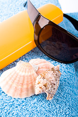 Image showing towel, shells, sunglasses and lotion