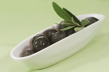 Image showing Black olives with leaf