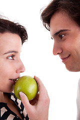 Image showing Woman seducing a man eating an apple