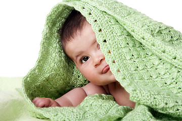 Image showing Cute happy baby between green blankets