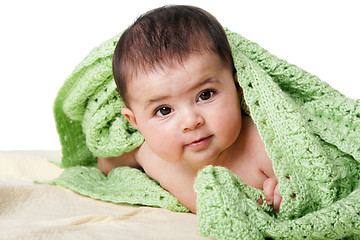 Image showing Cute happy baby between green blankets