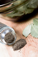 Image showing black pepper in shaker and bay leaves