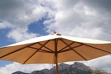 Image showing Sunshade against the rocks and sky