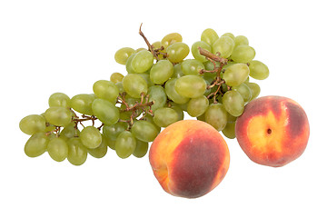 Image showing Green grapes bunch and two orange peach.