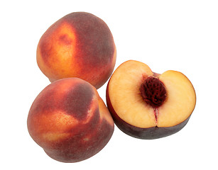 Image showing Three dark-red peach.