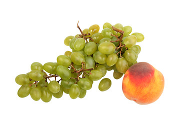 Image showing Green grapes bunch and one orange peach.