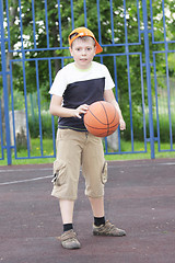 Image showing Boy tapping basketball