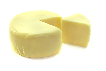 Image showing Cheese wheel with a piece of cheese