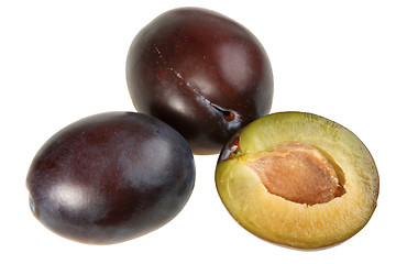 Image showing Three dark-purple plums.