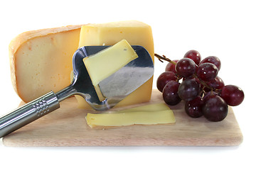 Image showing Cheese with a cheese slicer
