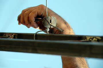 Image showing Worker hand with nippers