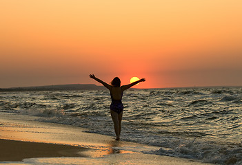 Image showing Young woman in a sunset