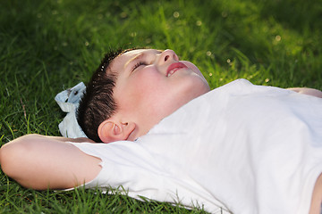 Image showing Boy laying down in grass