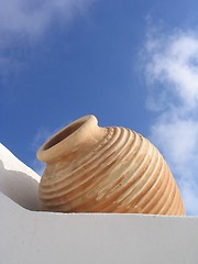Image showing White wall, beige vase, blue sky, Santorini, Greece