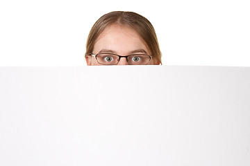 Image showing business woman peering over white sign