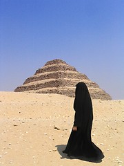 Image showing Woman passing in front of Step Pyramid at Sakkara, Egypt