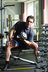 Image showing Man training biceps with dumb-bell