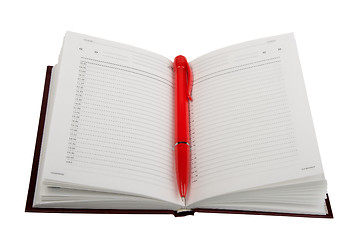 Image showing Empty open diary and red ball point pen.