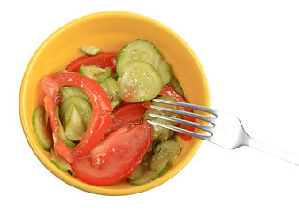 Image showing Salad from fresh cucumbers and tomatoes on a yellow plate