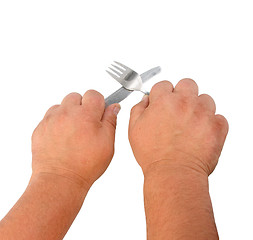 Image showing Two thick hands with knife and plug