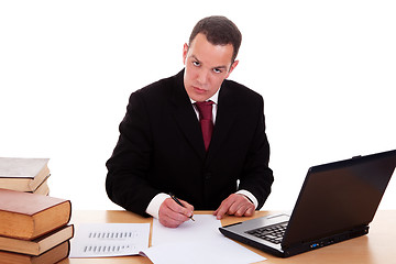 Image showing businessman on desk with books and computer, working