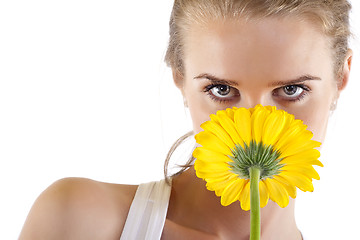 Image showing smelling a yellow flower