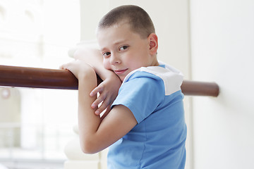 Image showing Boy standing at banister closeup