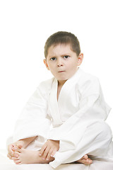 Image showing Little displeased karate kid legs crossed