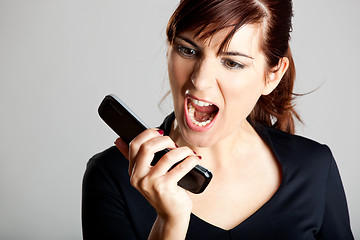 Image showing Unhappy woman at cellphone