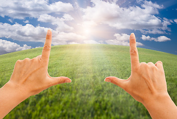 Image showing Female Hands Making a Frame Over Grass and Sky