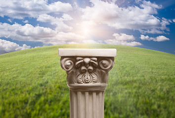 Image showing Ancient Replica Column Pillar Over Grass and Clouds