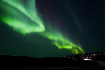 Image showing Aurora Borealis arc over hill terrain