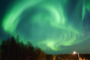 Image showing Round aurora over townlights