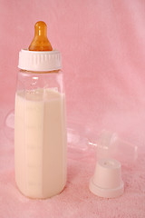 Image showing baby bottle over pink