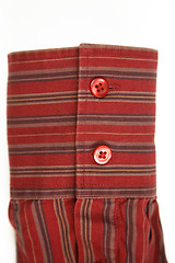 Image showing red cuff from striped shirt