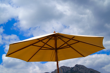 Image showing Sunshade against the rocks and sky