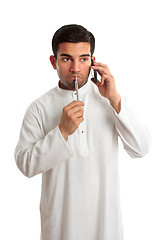 Image showing Worried ethnic man on phone