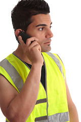 Image showing Tradesman on phone looking sideways