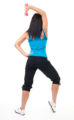 Image showing Back of woman standing and exercising with dumbbell