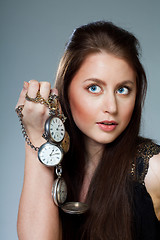 Image showing Woman with pocket clocks