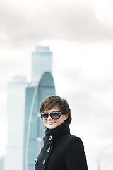 Image showing Smiling woman and skyscrapers