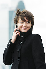 Image showing Woman on cellphone in windy day