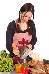 Image showing housewife preparing lunch and cutting carrot 