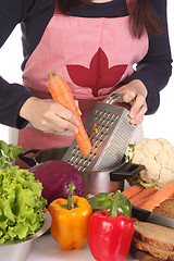 Image showing cutting carrot with stainless grater