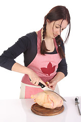 Image showing beautiful housewife cutting chicken 